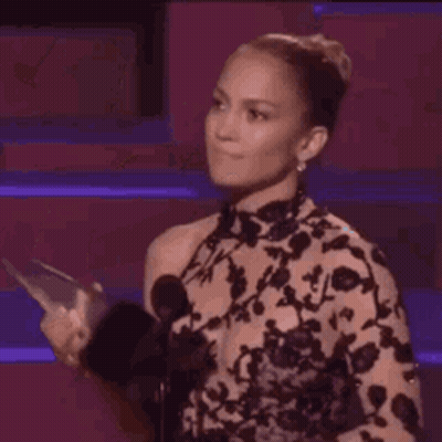 Woman Dancing On Stage Holding Cell Phone GIF