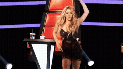 Woman Dancing On Stage In Front Of Red Chair GIF