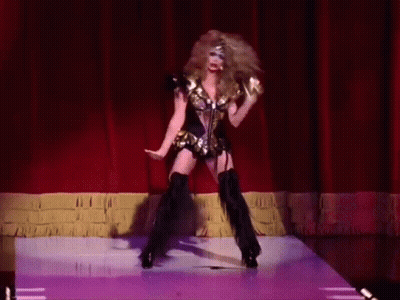 Woman Dancing On Stage With Red Curtain GIF