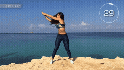 Woman Doing Exercises On Cliff Near Ocean 29 GIF