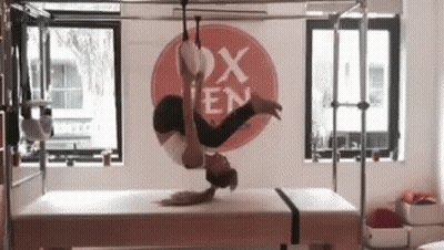Woman Doing Handstand On Bed In Gym GIF