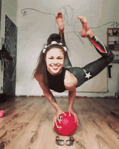 Woman Doing Handstand On Red Ball GIF