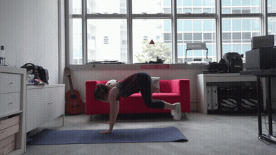 Woman Doing Push Ups By Red Couch Rock N Roll Sign GIF