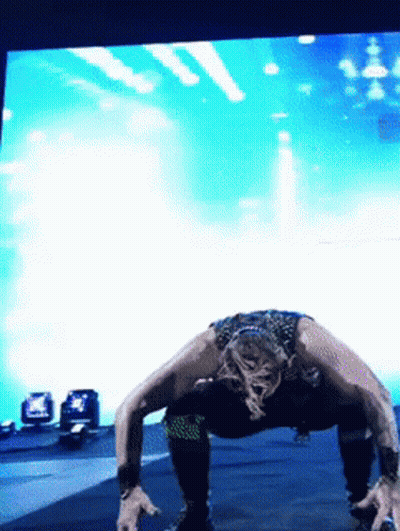 Woman Doing Push Ups In Front Of Blue Background GIF