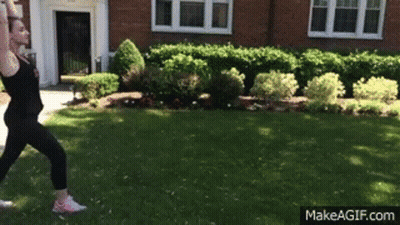 Woman Doing Yoga Pose In Front Of Brick Building GIF
