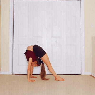 Woman Doing Yoga Pose In Front Of Door GIF