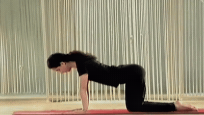 Woman Doing Yoga Pose On Mat GIF