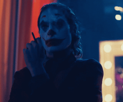 Woman Dressed As Clown Smoking GIF