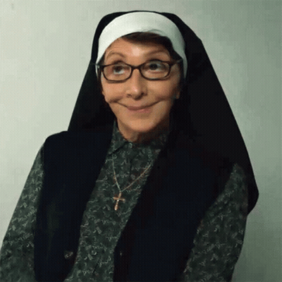 Woman Dressed As Nun With Glasses And Cross GIF