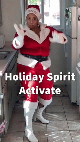 Woman Dressed As Santa Claus In Kitchen GIF