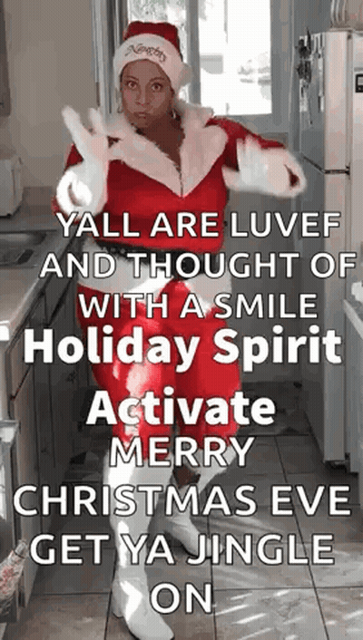 Woman Dressed As Santa In Kitchen GIF