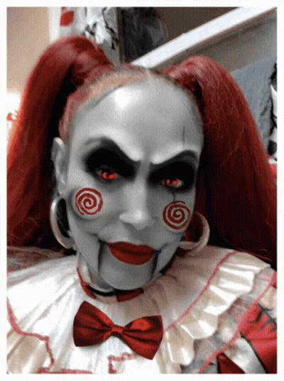 Woman Dressed as Scary Clown With Red Hair and Red Eyes