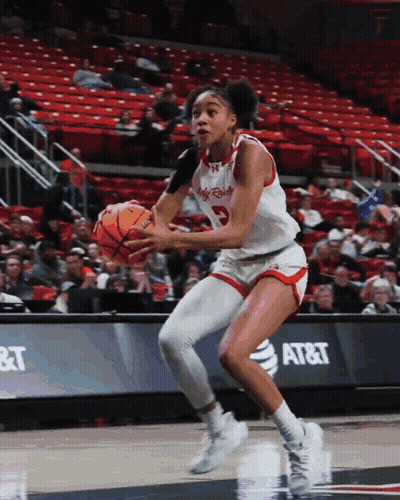 Woman Dribbling Basketball In Front Of AT&T Banner GIF