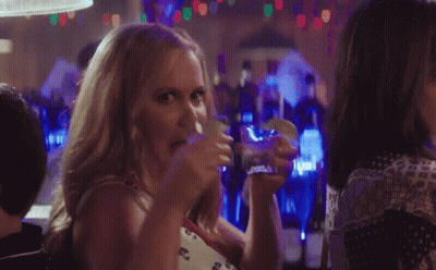Woman Drinking And Eating Taco In Bar GIF