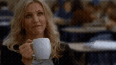 Woman Drinking Coffee in Classroom