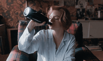 Woman Drinking From Bottle In Plaid Chair GIF