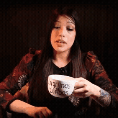 Woman Drinking From Cup Saying Lagrimas Turbos GIF