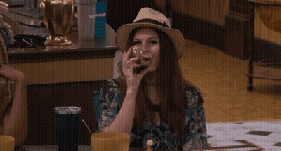 Woman Drinking From Glass With Hat GIF