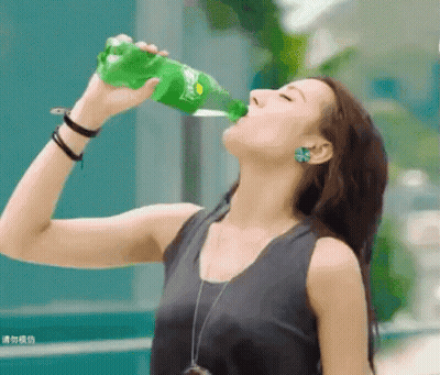 Woman Drinking From Green Sprite Bottle