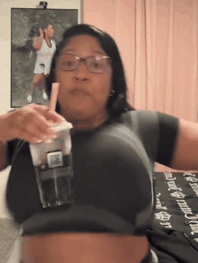 Woman Drinking From Plastic Cup With Pink Straw