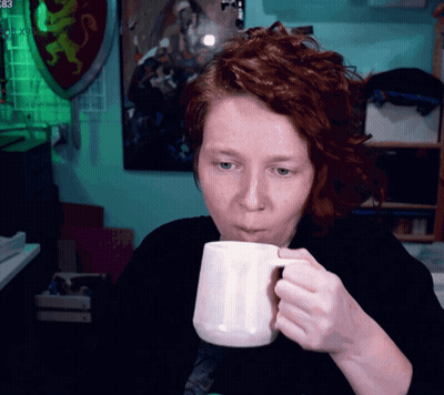 Woman Drinking From White Mug In Front Of 83 Sign GIF