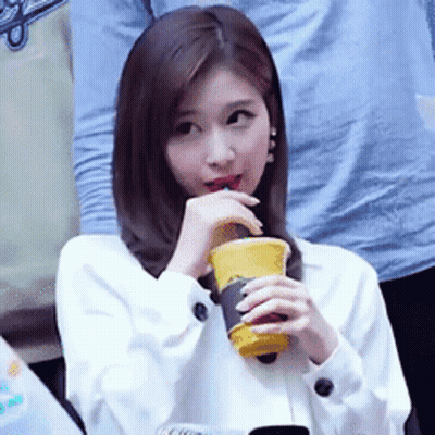 Woman Drinking From Yellow Cup GIF