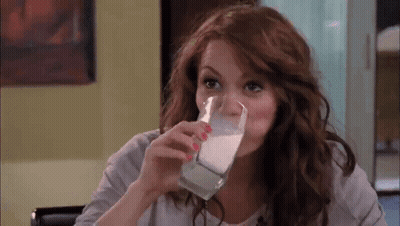 Woman Drinking Glass Of Milk At Table GIF