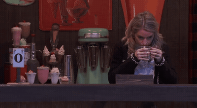 Woman Drinks From Glass Under 0 Degrees Sign GIF