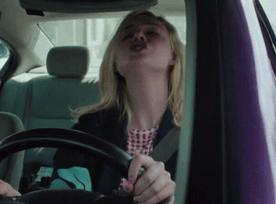 Woman Driving Car Making Funny Face GIF