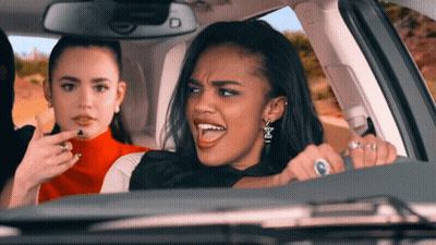 Woman Driving Car With Earrings Letter E GIF
