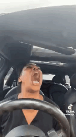 Woman Driving Car With Mouth Open Screaming GIF
