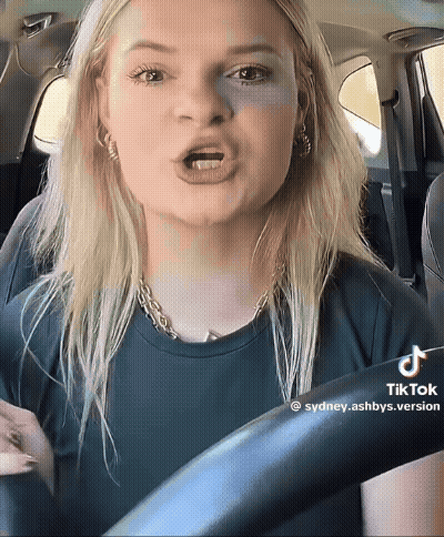 Woman Driving Car With TikTok Watermark GIF