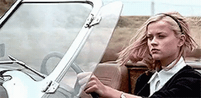 Woman Driving Car With Wind Blowing Hair