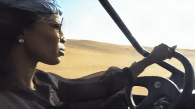 Woman Driving Vehicle In Desert GIF