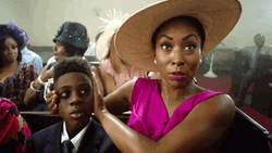 Woman Ear Plugs Her Son Inside Church GIF