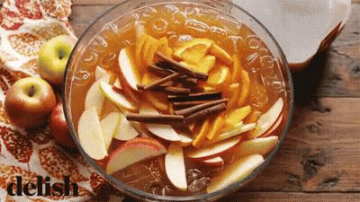 Woman Eating Apple From Man's Hand On Couch GIF