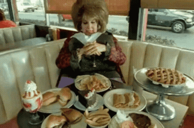 Woman Eating At Diner Table GIF