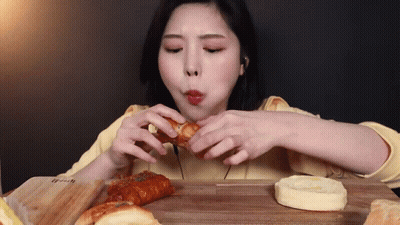 Woman Eating Bunch Of Bread GIF