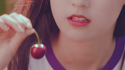 Woman Eating Cherry With Green Stem GIF