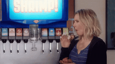 Woman Eating Chicken And Drinking Soda At Soda Machine GIF