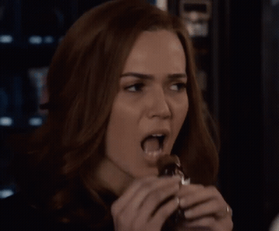 Woman Eating Chocolate Bar GIF