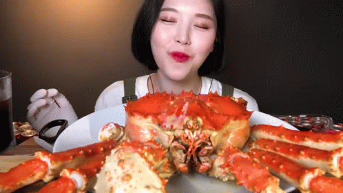 Woman Eating Crab Eyes Closed GIF