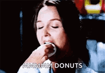 Woman Eating Donut Saying Mmmmm Donuts GIF