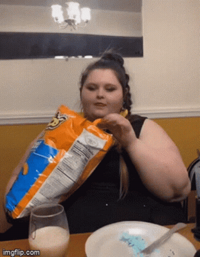 Woman Eating Doritos At Table GIF