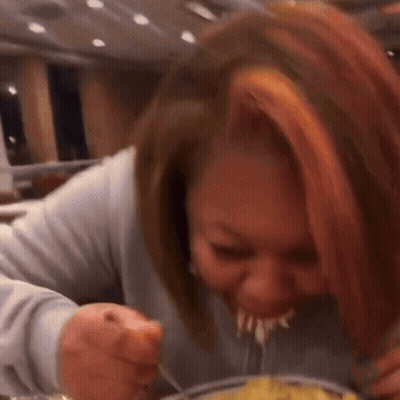Woman Eating Food At Table GIF