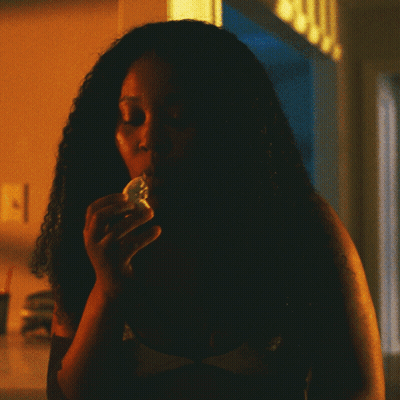 Woman Eating Food In Dark Room GIF