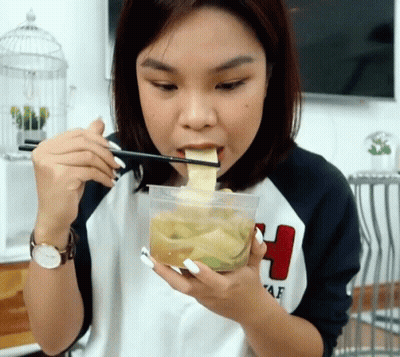 Woman Eating Food With Chopsticks GIF