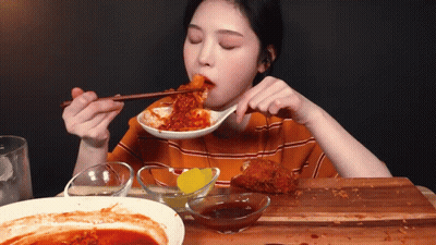 Woman Eating Food With Chopsticks And Sauce GIF