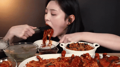 Woman Eating Food With Chopsticks GIF