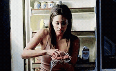 Woman Eating From Open Fridge GIF